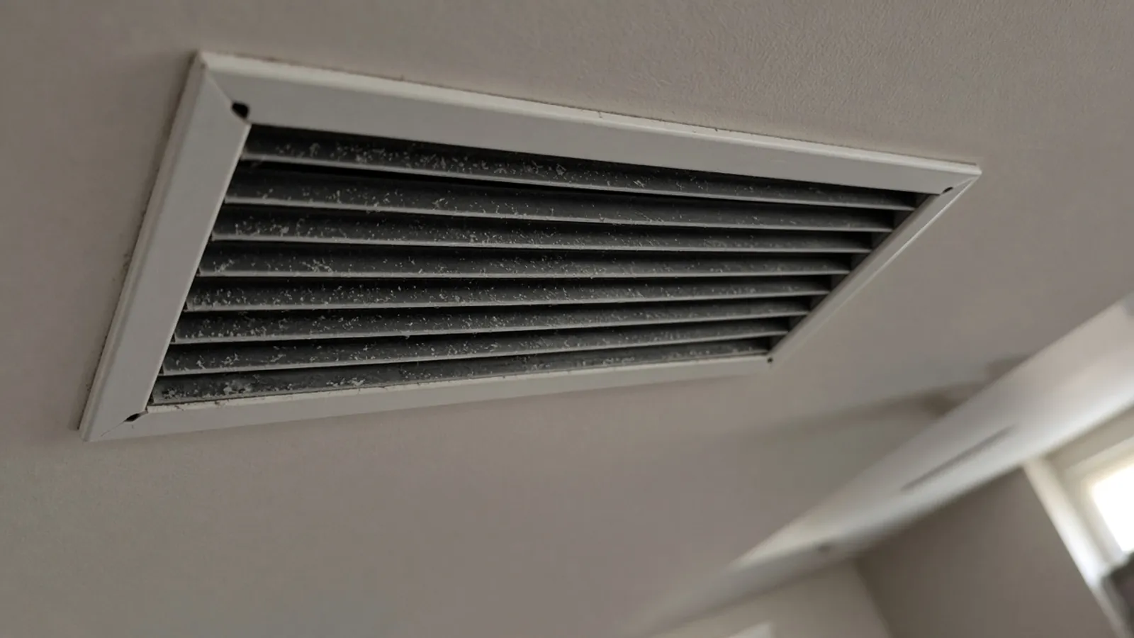 Ceiling air vent in a residential hallway